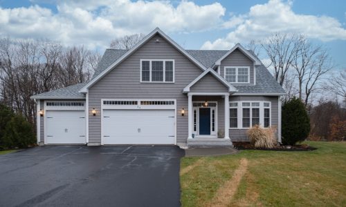 gray-walled-suburban-house-with-white-asphalt-driv-2025-02-08-01-05-19-utc-min